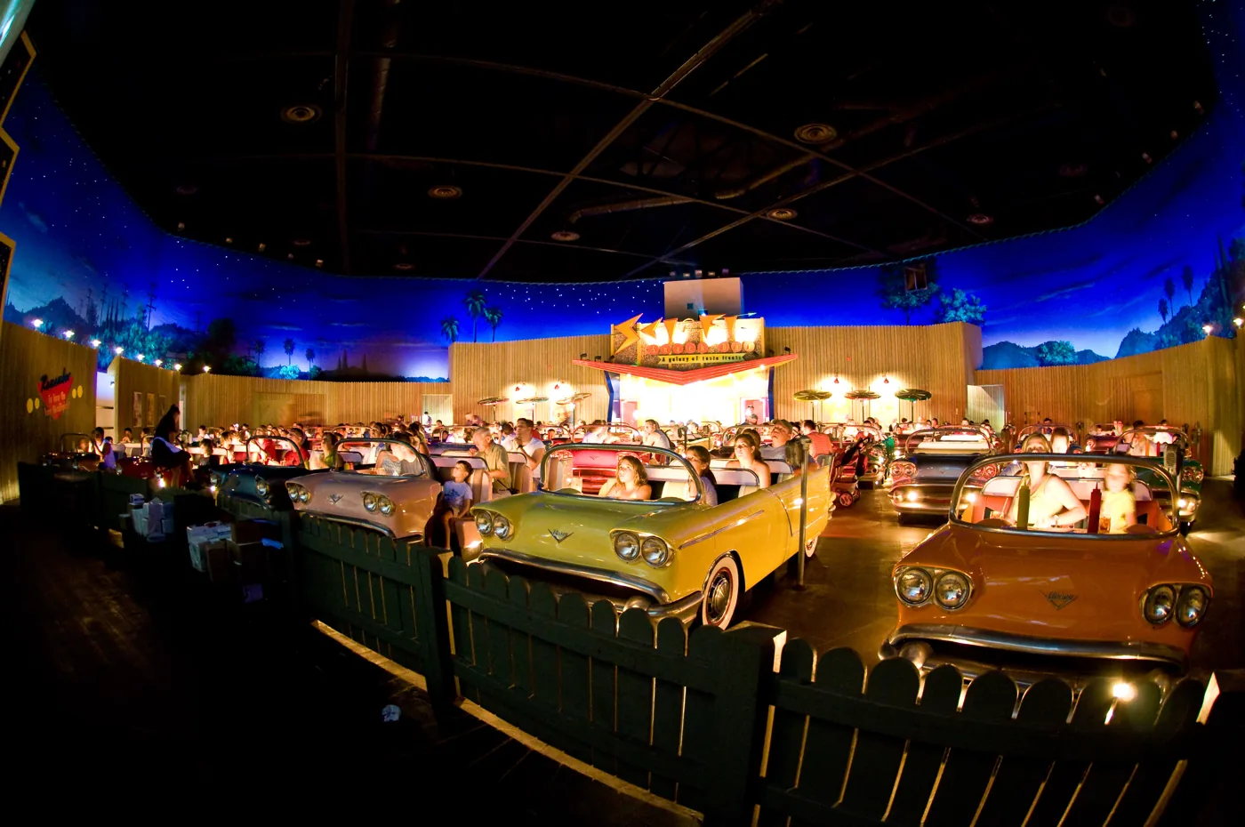 Car-shaped dining booths beneath the starry dining-room walls at Sci-Fi Dine-In