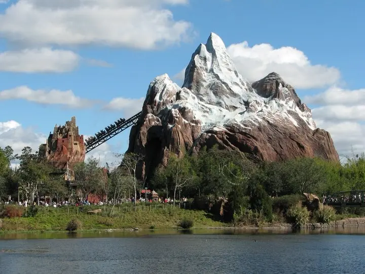 A coaster train climbing the snow-capped peak of Expedition Everest at Disney's Animal Kingdom