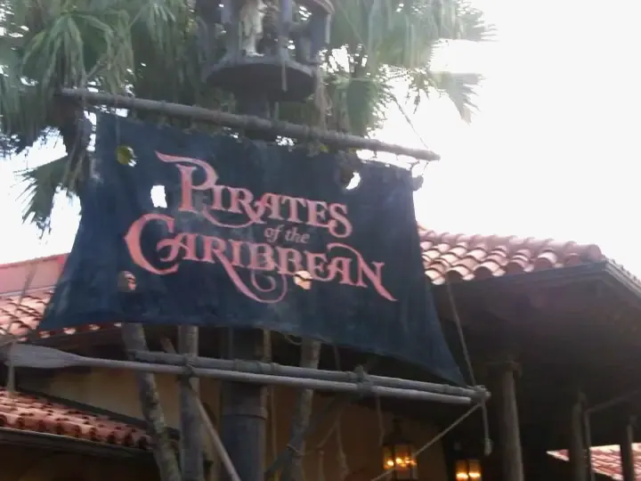 The tattered sail sign over the entrance to Pirates of the Caribbean at Magic Kingdom
