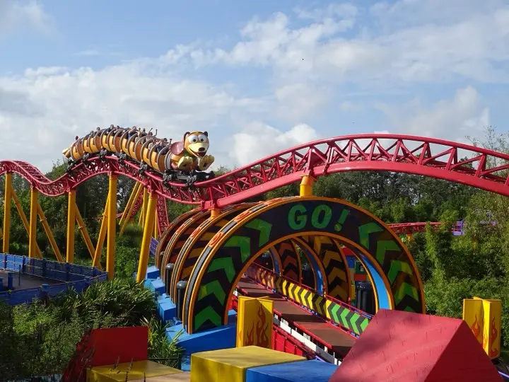 A Slinky Dog train cresting the red coaster track in Toy Story Land at Disney's Hollywood Studios