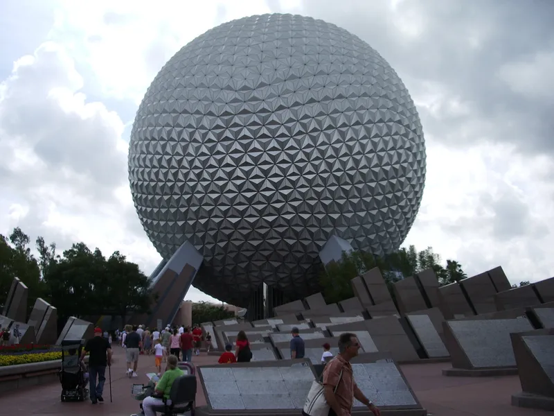 Spaceship Earth above the stone monoliths at the EPCOT entrance