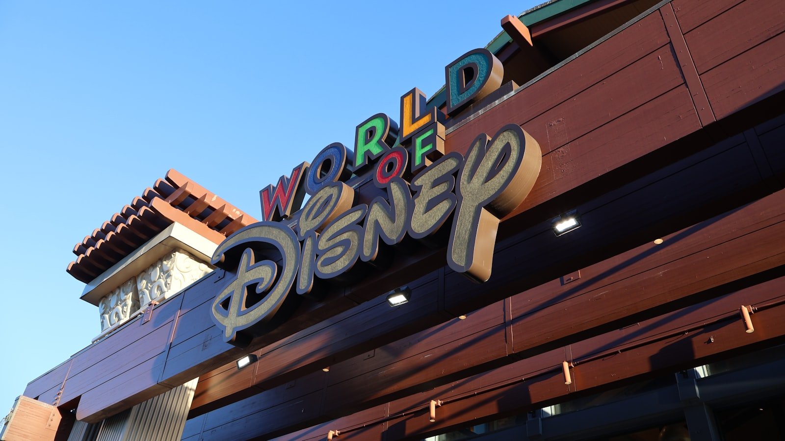 World of Disney store sign at Disney Springs against a clear blue sky
